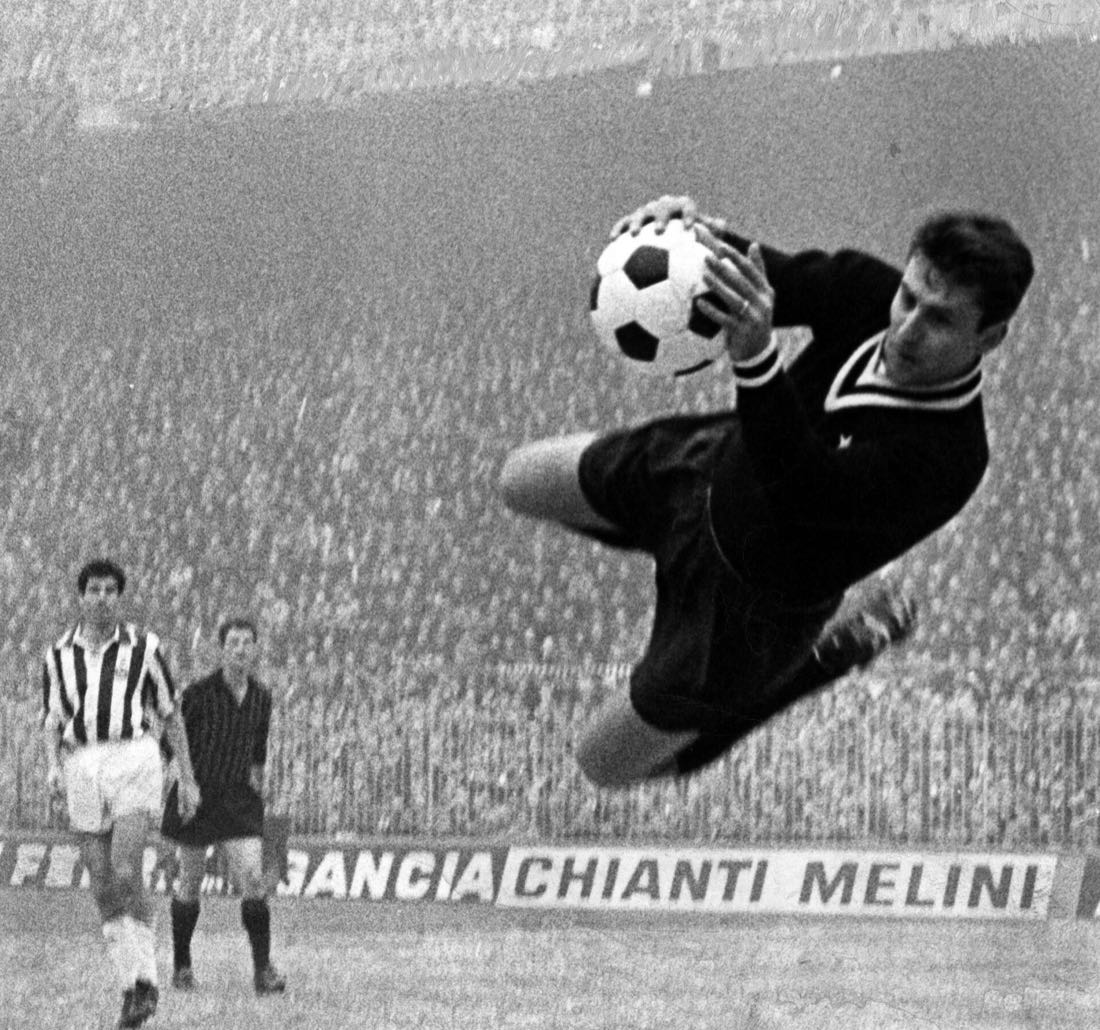 Un portiere si tuffa e blocca il pallone in una partita di Serie A del 1965